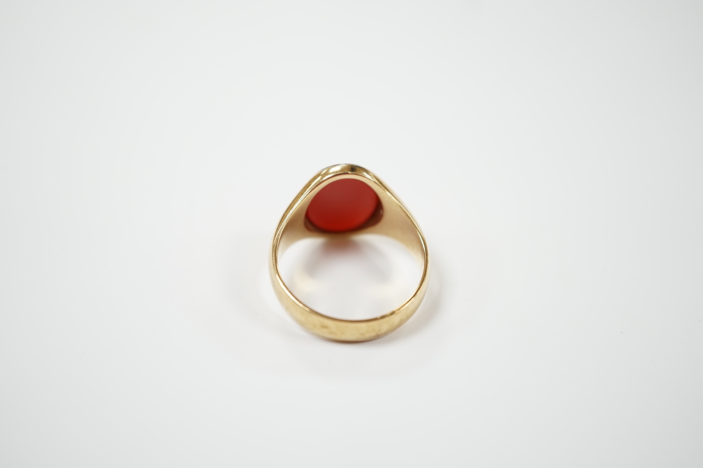 A 9ct gold and single stone oval carnelian set signet ring, size W, gross weight 8.7 grams.